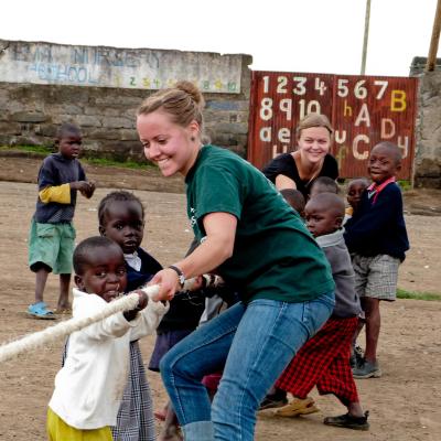 Projects Abroad volunteers work with children in Ghana. Childcare volunteer plays a game with children during her work experience in Ghana.